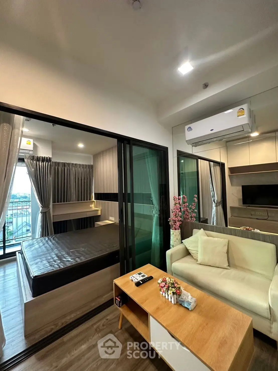 Modern studio apartment with open layout, featuring cozy living area and bedroom, perfect for urban living.