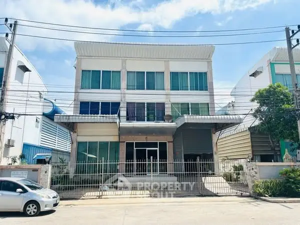 Modern commercial building with gated entrance and large windows