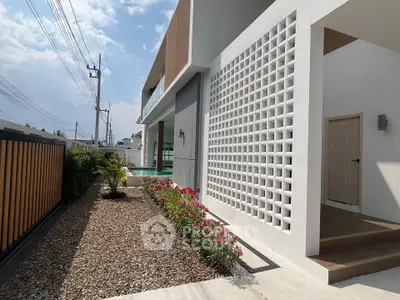 Modern exterior of a stylish home with unique architectural design and landscaped garden.