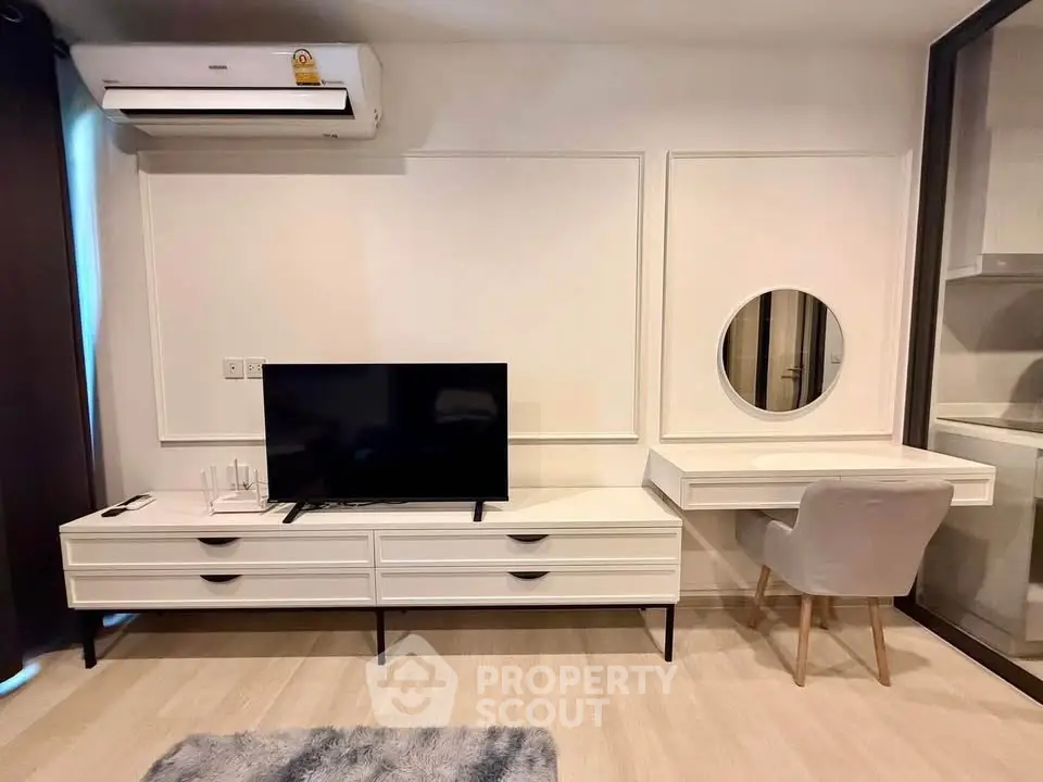 Modern living room with sleek TV stand, air conditioning, and stylish vanity desk.