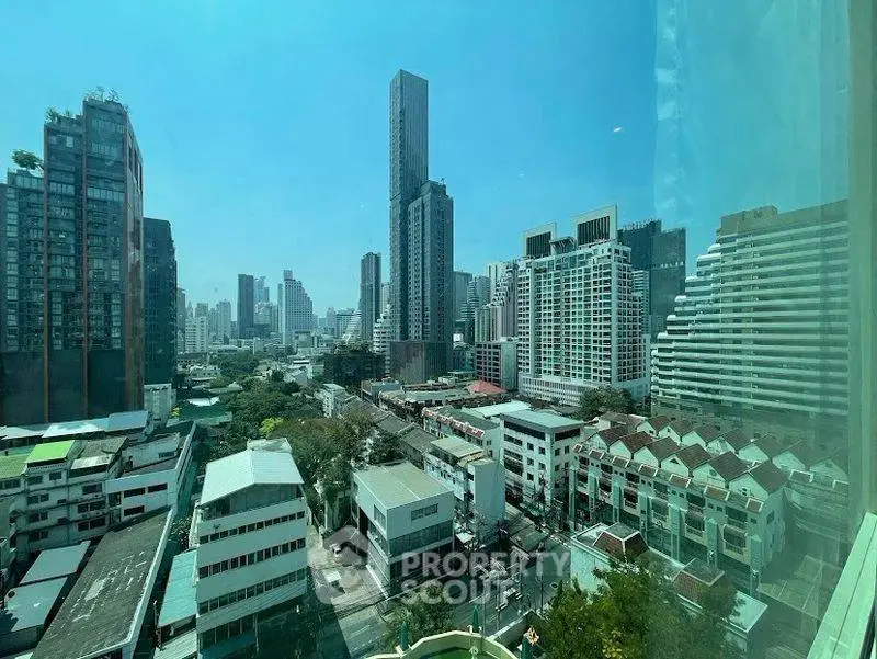 Stunning cityscape view from high-rise building showcasing urban skyline and modern architecture.