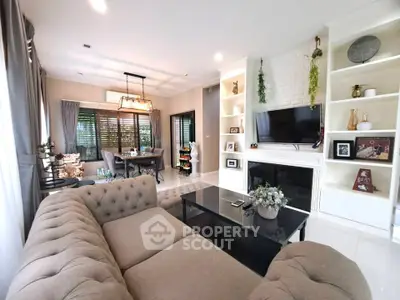 Elegant living room with cozy sectional sofa, modern decor, and dining area in open layout.