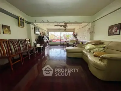 Spacious living room with polished wooden floors and comfortable seating