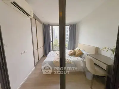 Modern bedroom with large window and stylish decor