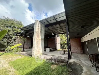 Spacious outdoor area with modern industrial design and lush greenery