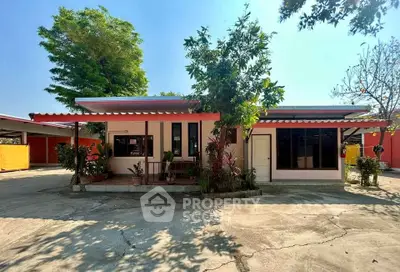 Charming single-story home with lush greenery and spacious driveway, perfect for serene living.