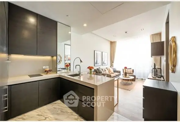 Modern open-layout kitchen and living room with sleek design and natural light.