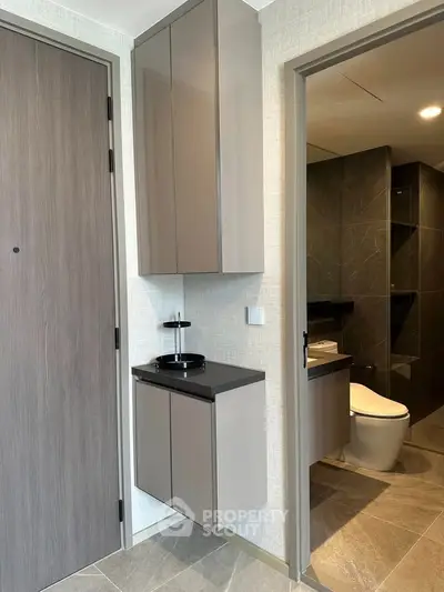 Modern bathroom with sleek cabinetry and contemporary design in a stylish apartment.