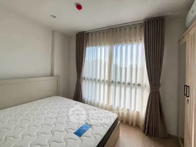 Bright and airy bedroom with large window and modern furnishings
