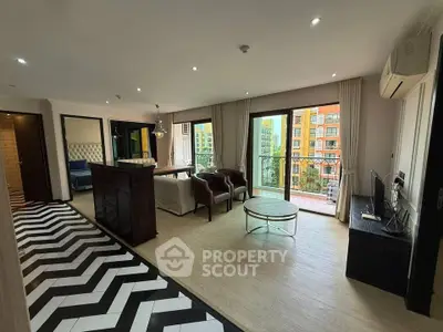 Spacious modern living room with stylish decor and balcony view in luxury apartment.