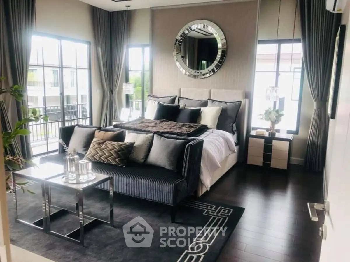 Luxurious bedroom with elegant decor and large windows for natural light.