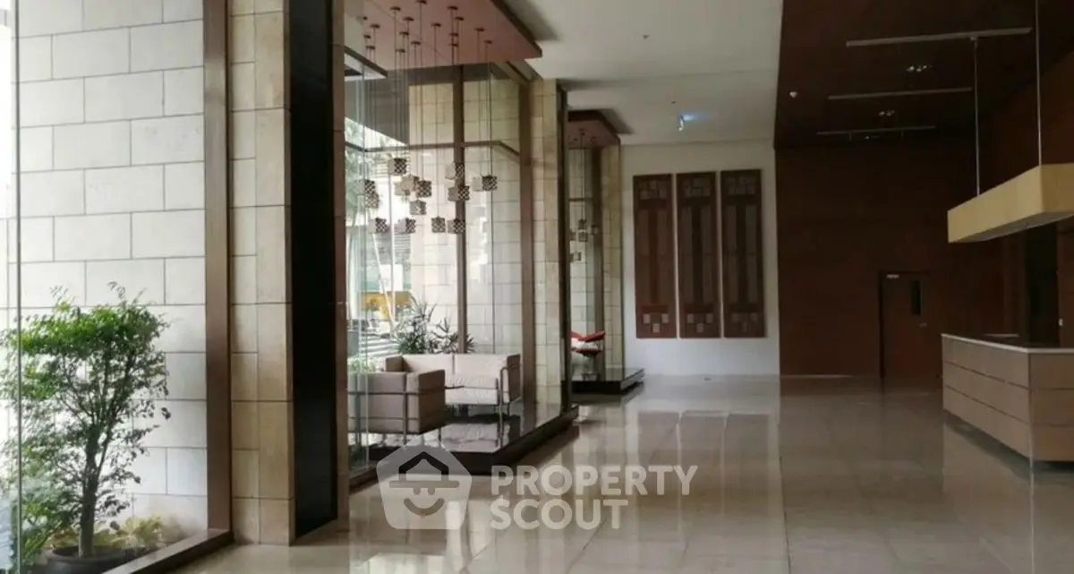 Luxurious modern building entrance with elegant decor and spacious lobby area.