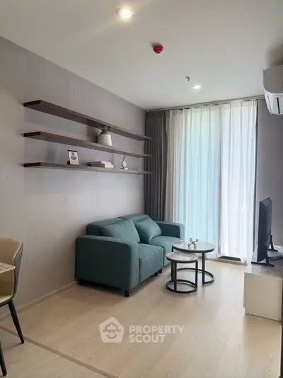 Modern living room with stylish decor and natural light, featuring a cozy sofa and elegant shelving.