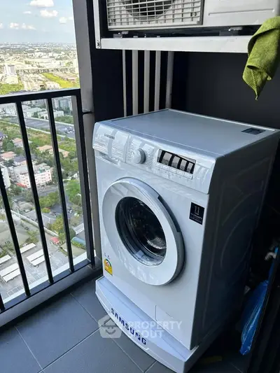 High-rise balcony with Samsung washing machine and city view, perfect for urban living convenience.