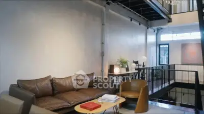 Stylish modern living room with leather sofa and open loft design