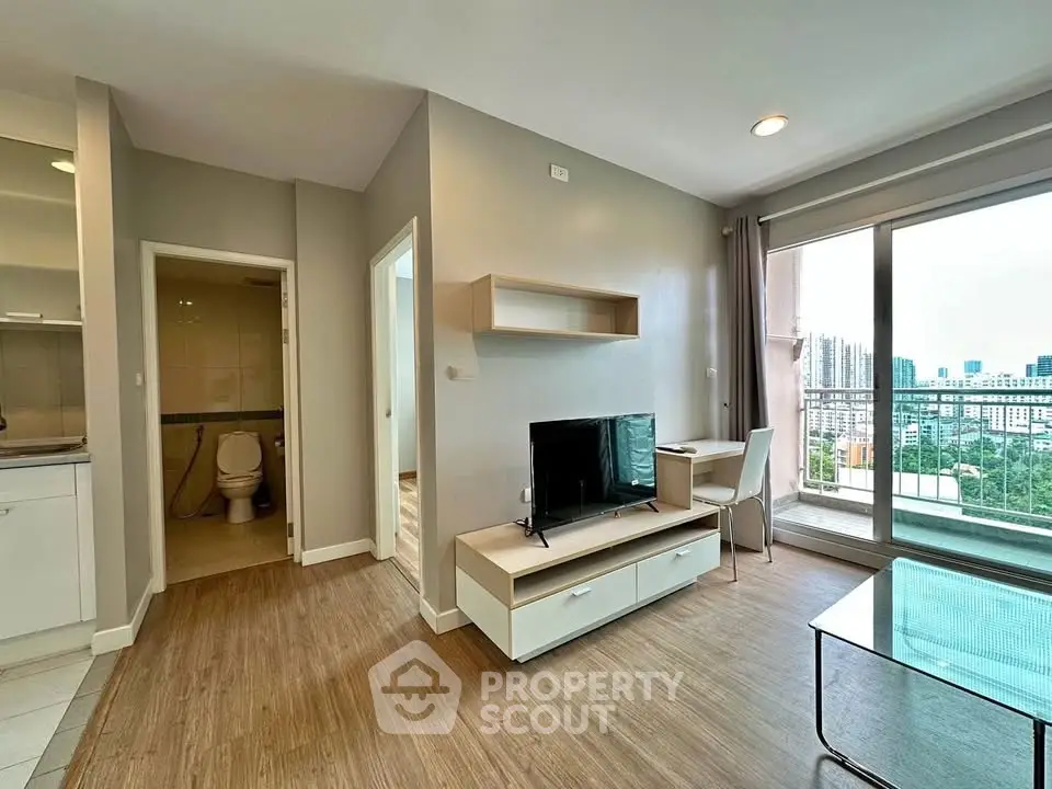 Modern living room with city view, featuring sleek furniture and large windows for natural light.