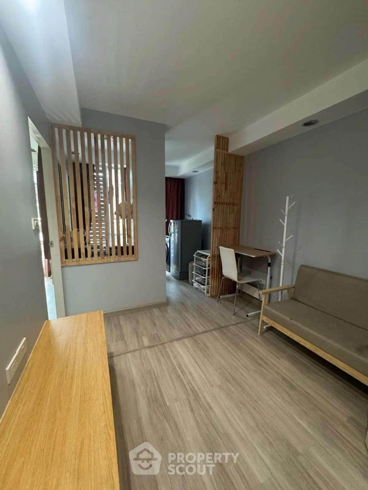 Modern apartment interior with sleek wooden accents and cozy seating area.
