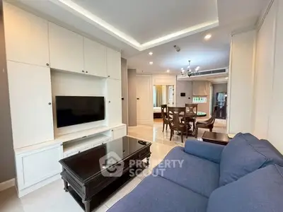 Spacious living room with modern furniture and elegant dining area in open layout.