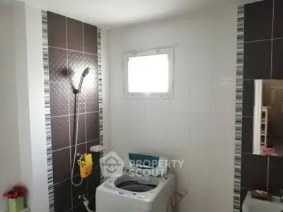 Modern bathroom with washing machine and stylish tile design