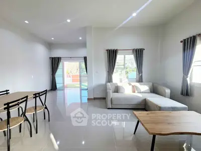 Spacious modern living room with natural light and stylish furniture