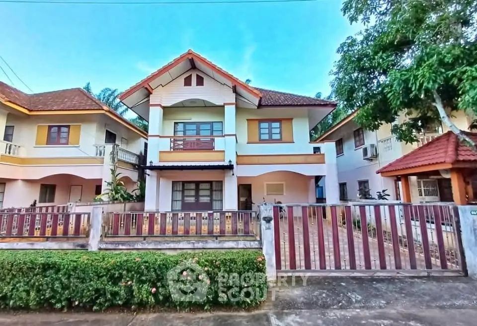 Charming two-story house with spacious driveway and lush greenery in a serene neighborhood.