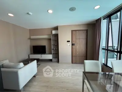 Modern living room with sleek furniture and large windows in a stylish apartment.