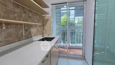 Modern kitchen with sleek design and large windows for natural light