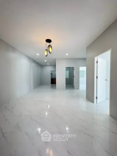 Spacious modern interior with marble flooring and elegant lighting, perfect for contemporary living.