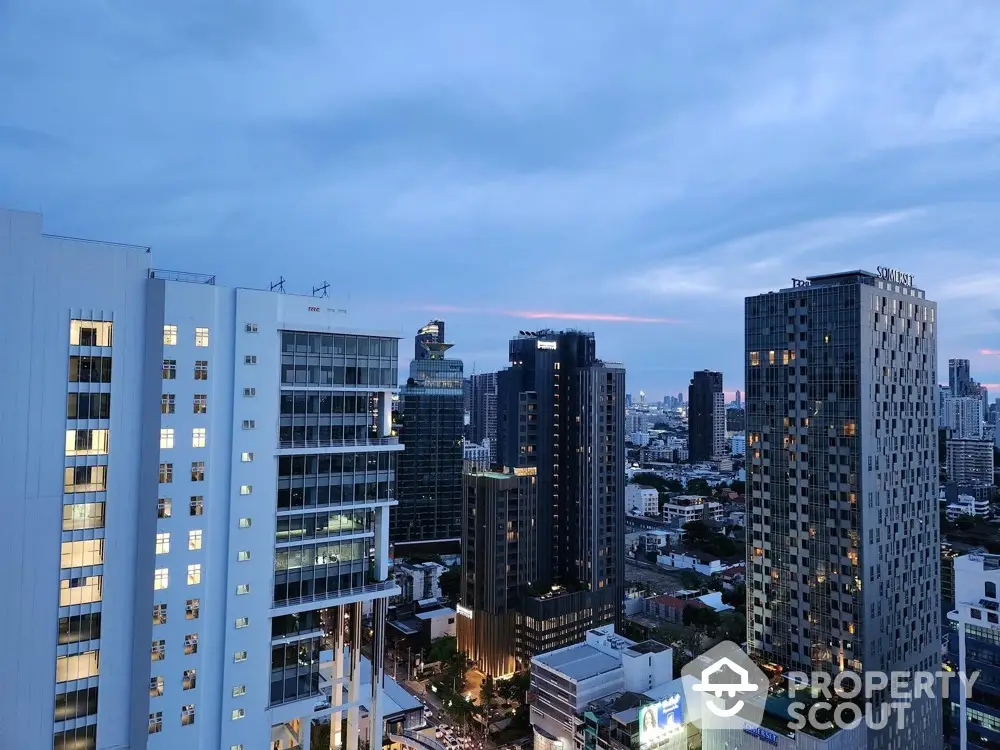 Stunning cityscape view from high-rise buildings at dusk, showcasing urban skyline and vibrant architecture.