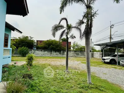 Spacious residential property with lush greenery and ample parking space