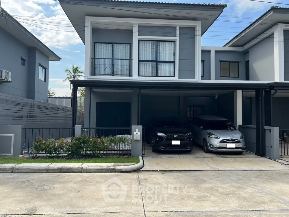 Modern two-story house with double garage and sleek exterior design