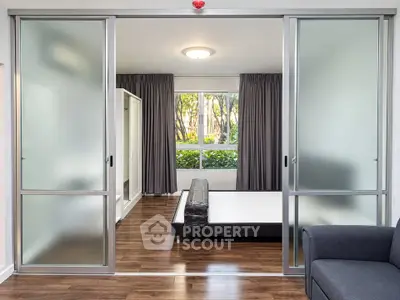 Modern bedroom with sliding glass doors and garden view