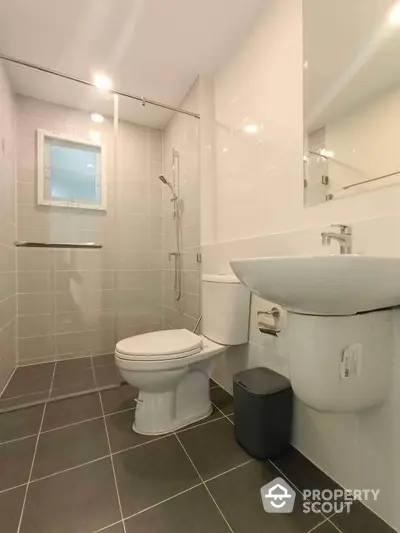 Modern bathroom with sleek fixtures and tiled walls in a contemporary home.