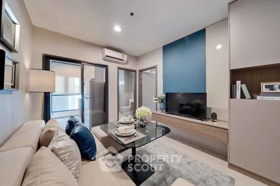 Modern living room with stylish decor and open layout, featuring a cozy sofa and sleek TV unit.