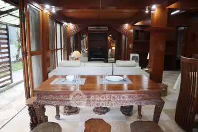 Luxurious living room with elegant wooden furniture and garden view