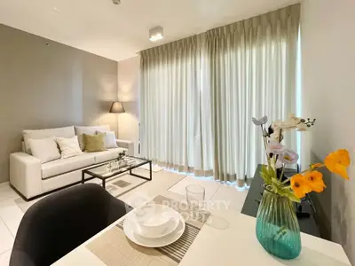 Modern living room with elegant decor and natural light, featuring a cozy sofa and stylish dining area.