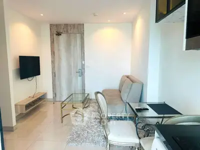 Modern living room with stylish furniture and wall-mounted TV in a cozy apartment.