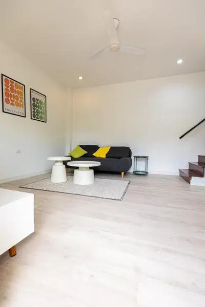 Bright modern living room with stylish decor and cozy seating area.