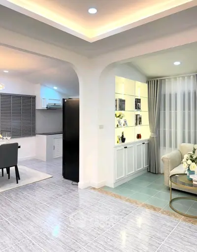 Modern open-plan living and dining area with elegant decor and stylish lighting.