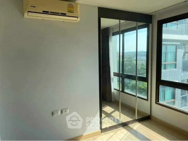 Bright corner unit with mirrored closet and large windows offering a great view.