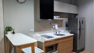 Modern kitchen with sleek appliances and stylish dining area