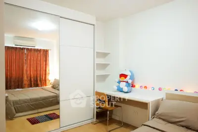 Cozy bedroom with study area, featuring a plush toy and ambient lighting.