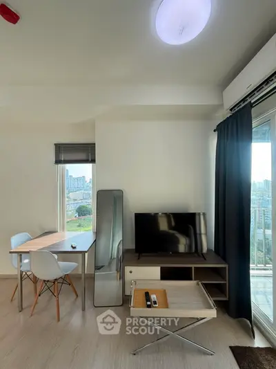 Modern living room with city view, stylish furniture, and natural light.