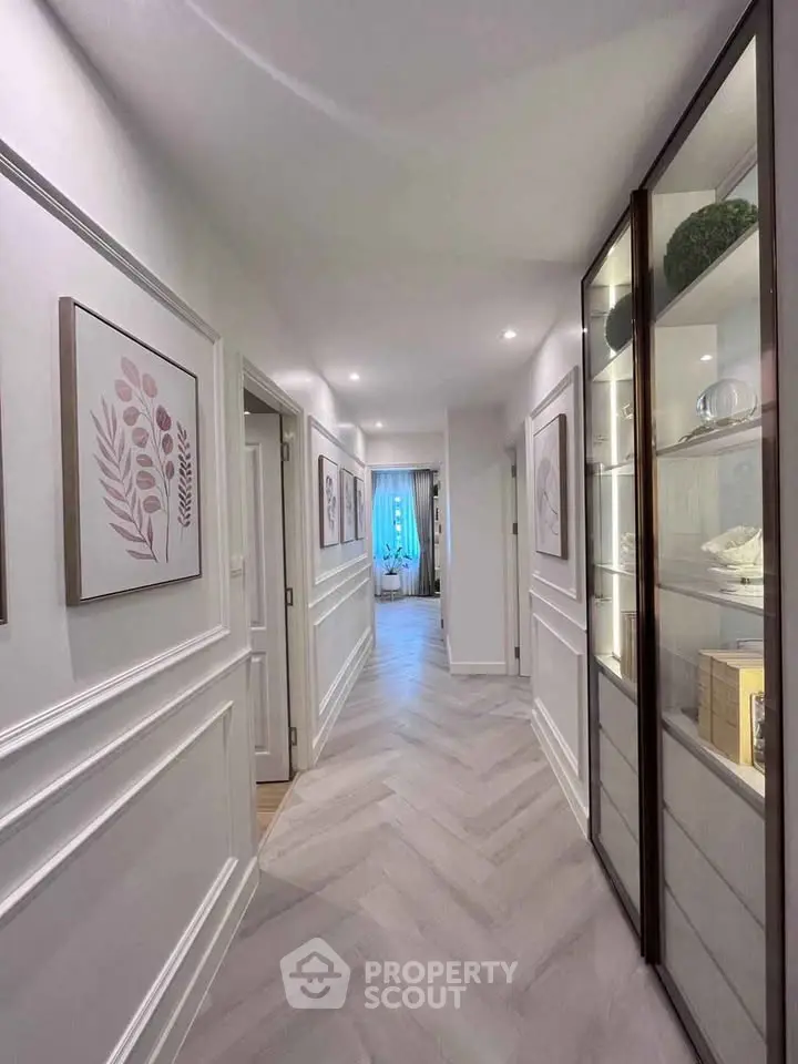 Elegant hallway with modern decor and stylish lighting leading to a cozy room.