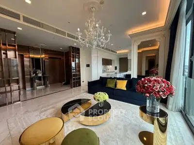 Luxurious living room with elegant chandelier and modern decor in high-end apartment.