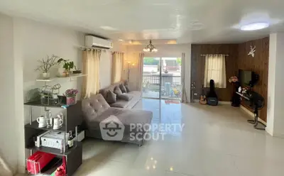 Spacious living room with modern decor and large windows for natural light