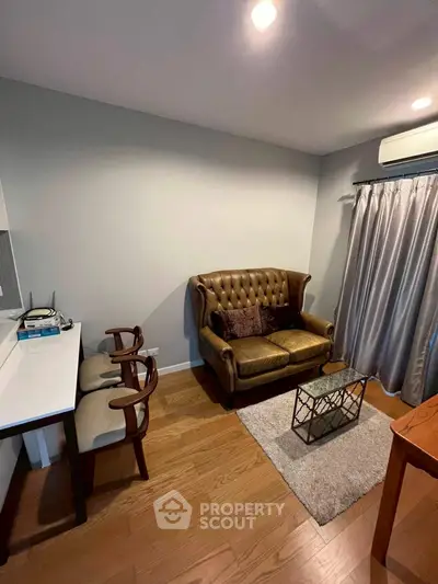 Cozy living room with leather sofa and modern decor in a stylish apartment.