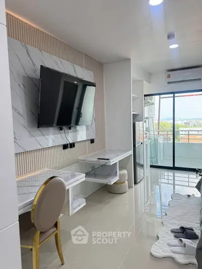 Modern living room with sleek TV setup and balcony view