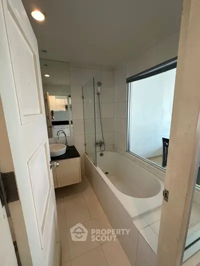 Modern bathroom with bathtub and sleek design in a contemporary apartment.