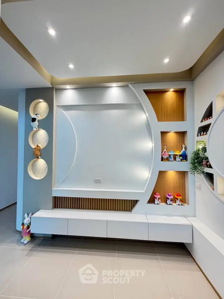 Modern living room with stylish built-in shelves and elegant lighting